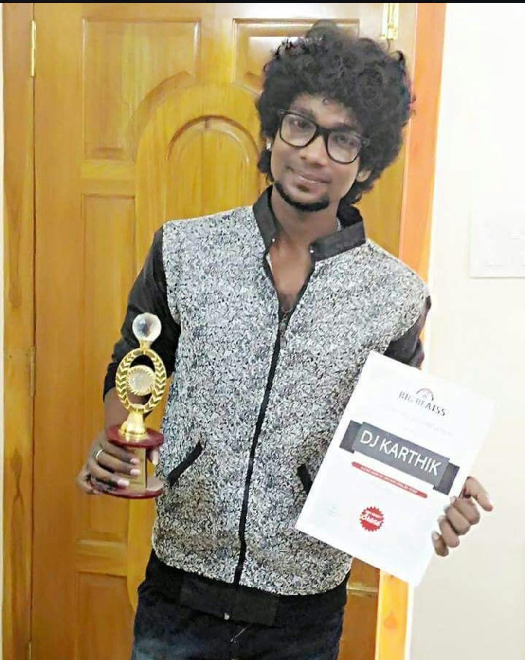 DJ Karthi holding a Big Beats best DJ award and certificate in Chennai